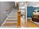 Traditional staircase with hardwood floors and custom millwork leads to the upper level, blending classic charm at 4530 Upland Court, Cumming, GA 30040