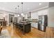 Spacious kitchen with island seating, stainless steel appliances, and hardwood flooring at 4530 Upland Court, Cumming, GA 30040