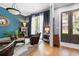 Stylish living room featuring bright blue walls, hardwood floors, and lots of natural light at 4530 Upland Court, Cumming, GA 30040