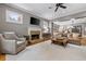 Open-concept living room with fireplace, ceiling fan, and view into the dining room at 4530 Upland Court, Cumming, GA 30040