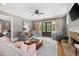 Cozy living room with fireplace, French doors, and comfortable seating area for relaxation at 4530 Upland Court, Cumming, GA 30040