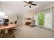 Bright office space with a large window offering a view of the backyard, plus space for both work and relaxation at 4530 Upland Court, Cumming, GA 30040