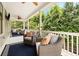 Relaxing covered patio with comfortable seating and a peaceful view of the surrounding trees at 4530 Upland Court, Cumming, GA 30040