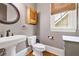 Stylish powder room features a pedestal sink, a window, and a modern design at 4530 Upland Court, Cumming, GA 30040