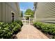 Stone walkway leading to a white garden gate, surrounded by lush landscaping at 4530 Upland Court, Cumming, GA 30040