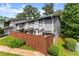 Well-maintained townhome featuring gray siding, wooden privacy fence, and a well-manicured lawn at 5040 Meadow Lane Ne, Marietta, GA 30068