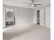 Main bedroom with ensuite bathroom, neutral carpet, ceiling fan and double closets at 5040 Meadow Lane Ne, Marietta, GA 30068
