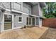 Exterior view showcasing a private concrete patio with white-trimmed doors and siding at 5040 Meadow Lane Ne, Marietta, GA 30068