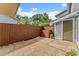 Inviting outdoor patio area enclosed by a wooden privacy fence and manicured green bushes at 5040 Meadow Lane Ne, Marietta, GA 30068