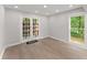 Bright, airy room featuring wood floors, recessed lighting, and double doors to the exterior at 5040 Meadow Lane Ne, Marietta, GA 30068