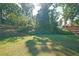 Expansive backyard with lush green grass and mature trees at 686 Stark St, Lawrenceville, GA 30046