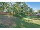 Scenic backyard with a gentle slope, a green lawn, and a wooden fence at 686 Stark St, Lawrenceville, GA 30046