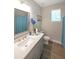 Well-lit bathroom featuring modern fixtures, a large mirror, and wood-look flooring at 686 Stark St, Lawrenceville, GA 30046