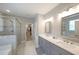 Elegant bathroom with double vanity, quartz countertops, glass-enclosed shower and soaking tub at 686 Stark St, Lawrenceville, GA 30046