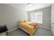 Cozy bedroom with plush carpet, a comfortable bed, and a bright window at 686 Stark St, Lawrenceville, GA 30046