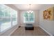 Bright dining room with large windows and stylish ottoman seating beneath a modern chandelier at 686 Stark St, Lawrenceville, GA 30046