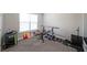 Home gym featuring carpet floors, large windows for natural light, and exercise equipment at 686 Stark St, Lawrenceville, GA 30046