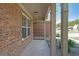 Close up view of the brick wall and pillars of the home's covered front porch at 686 Stark St, Lawrenceville, GA 30046
