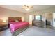 Cozy main bedroom featuring a large window, ceiling fan, and rustic-style wooden furniture at 686 Stark St, Lawrenceville, GA 30046