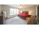 Spacious main bedroom with a large window, ceiling fan, and rustic-style furniture at 686 Stark St, Lawrenceville, GA 30046