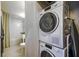 Contemporary bathroom with a stacked washer and dryer adjacent to the shower and toilet at 130 26Th Nw St # 701, Atlanta, GA 30309
