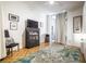 Well-lit bedroom showcasing a modern television, classic book stand, and views of the outdoors at 130 26Th Nw St # 701, Atlanta, GA 30309