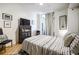 Bedroom featuring light and airy decor with a large TV and adjacent balcony at 130 26Th Nw St # 701, Atlanta, GA 30309