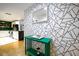 Stylish hallway features geometric wallpaper, a console table, and an entrance into a modern kitchen at 130 26Th Nw St # 701, Atlanta, GA 30309