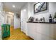 Hallway with bar area featuring modern cabinets, striking wallpaper, and hardwood floors at 130 26Th Nw St # 701, Atlanta, GA 30309