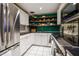 Well-lit kitchen features white cabinets, stainless steel appliances, open shelving, and a dark countertop at 130 26Th Nw St # 701, Atlanta, GA 30309