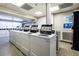 Bright community laundry room with multiple washing machines at 130 26Th Nw St # 701, Atlanta, GA 30309