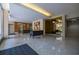 A well lit and stylish lobby with granite floors, decorative lighting, and comfortable seating at 130 26Th Nw St # 701, Atlanta, GA 30309