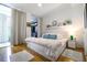 Serene bedroom with sliding glass doors leading to a balcony and a view of the outside at 130 26Th Nw St # 701, Atlanta, GA 30309