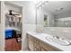 Bathroom vanity with double sinks, a large mirror, and access to the bedroom at 1533 High Haven Ne Ct, Atlanta, GA 30329