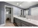 Bright bathroom featuring a double vanity, large mirror, and unique patterned wallpaper at 1533 High Haven Ne Ct, Atlanta, GA 30329