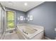 A spacious bathroom featuring a large soaking tub and tile surround, offering a relaxing retreat at 1533 High Haven Ne Ct, Atlanta, GA 30329