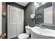 Stylish half bathroom features a modern sink, decorative art, and ample storage, providing convenience and style at 1533 High Haven Ne Ct, Atlanta, GA 30329