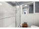Bathroom features a white tiled shower with glass doors and tile walls in a white finish at 1533 High Haven Ne Ct, Atlanta, GA 30329