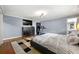 Spacious bedroom with hardwood floors, ceiling fan, TV, dresser, and a treadmill at 1533 High Haven Ne Ct, Atlanta, GA 30329