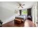 Bedroom features hardwood floors, a ceiling fan, and a bright window overlooking the backyard at 1533 High Haven Ne Ct, Atlanta, GA 30329