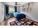 Bedroom with hardwood floors, ceiling fan, curtains and sport pennants on the wall at 1533 High Haven Ne Ct, Atlanta, GA 30329