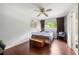 Cozy bedroom with hardwood floors, a ceiling fan, and bright window letting in light at 1533 High Haven Ne Ct, Atlanta, GA 30329