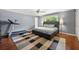 Spacious bedroom featuring a king-sized bed, hardwood floors, modern ceiling fan, and natural light at 1533 High Haven Ne Ct, Atlanta, GA 30329