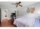 Bedroom features a ceiling fan, hardwood floors, and a view into the bathroom at 1533 High Haven Ne Ct, Atlanta, GA 30329
