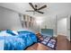 Bedroom with hardwood floor, ceiling fan, sports decor, and neutral colored walls at 1533 High Haven Ne Ct, Atlanta, GA 30329