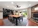 Dining room featuring a stone fireplace, wet bar, and access to the backyard at 1533 High Haven Ne Ct, Atlanta, GA 30329