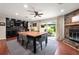 Dining area with hardwood floors, a stone fireplace, and access to the backyard at 1533 High Haven Ne Ct, Atlanta, GA 30329