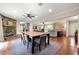 Open concept living and dining area with hardwood floors and a fireplace at 1533 High Haven Ne Ct, Atlanta, GA 30329