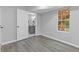 Bedroom view into bathroom: Neutral tones, window to outside, and white trim at 2599 Willow Creek Dr, Duluth, GA 30096