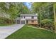 Charming two-story home featuring a welcoming porch, a two-car garage, and a well-manicured lawn at 2599 Willow Creek Dr, Duluth, GA 30096
